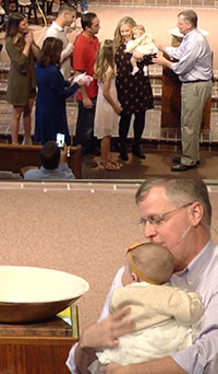 Baby girl getting baptized by pastor